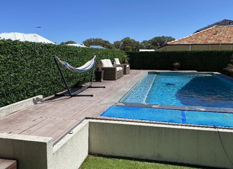 Small sample of Designer Plants USA Spring Sensation Green Wall with artificial ivy panel installed along pool and deck area.