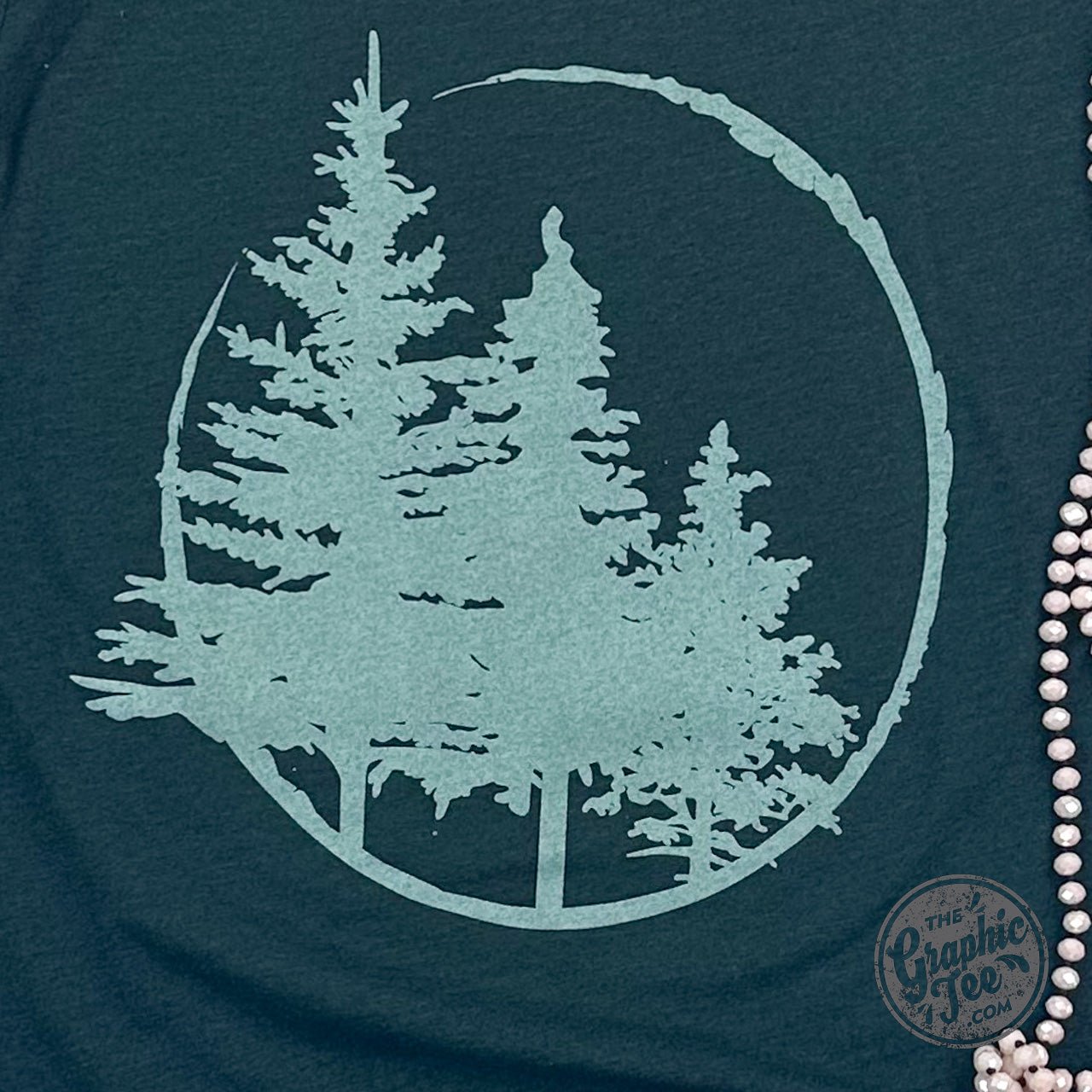 Evergreens Heather Emerald short sleeve graphic tee by The Graphic Tee, featuring a vibrant green design on soft fabric.