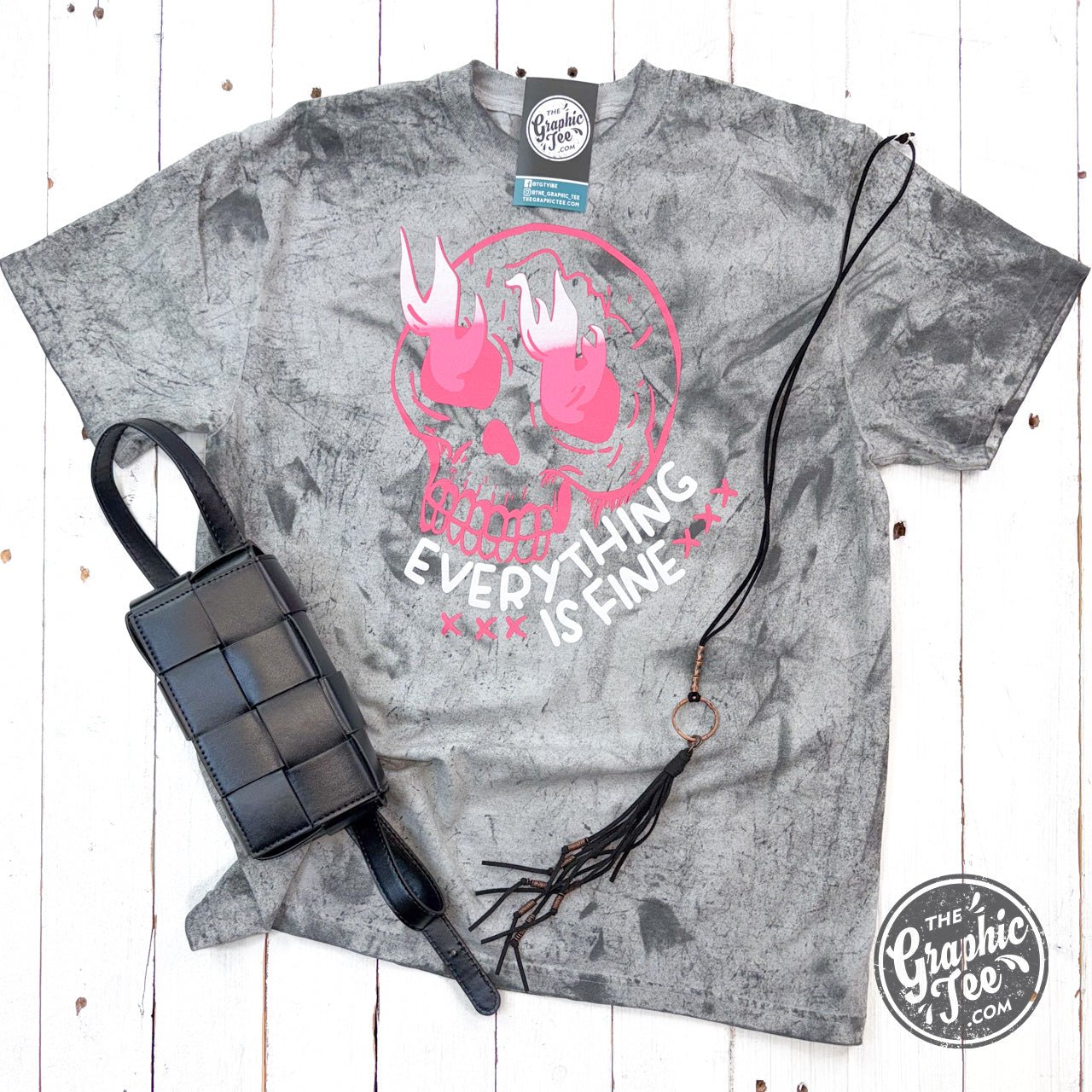 Graphic SS T-shirt by The Graphic Tee featuring a skull design, pigment-dyed colorblast print on a casual crewneck tee.