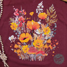 Fall Boho floral Heather Cardinal V-neck short sleeve graphic tee from The Graphic Tee, featuring a vibrant floral design and crew neck.