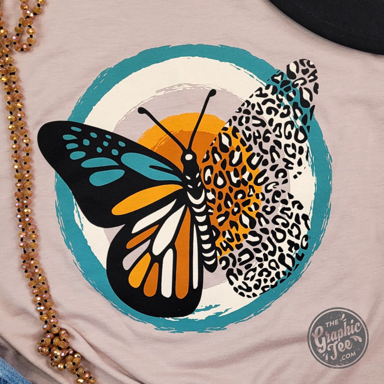Heather pink short sleeve graphic tee with fall butterfly design by The Graphic Tee, featuring a casual, stylish summer look.