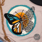 Heather pink short sleeve graphic tee with fall butterfly design by The Graphic Tee, featuring a casual, stylish summer look.