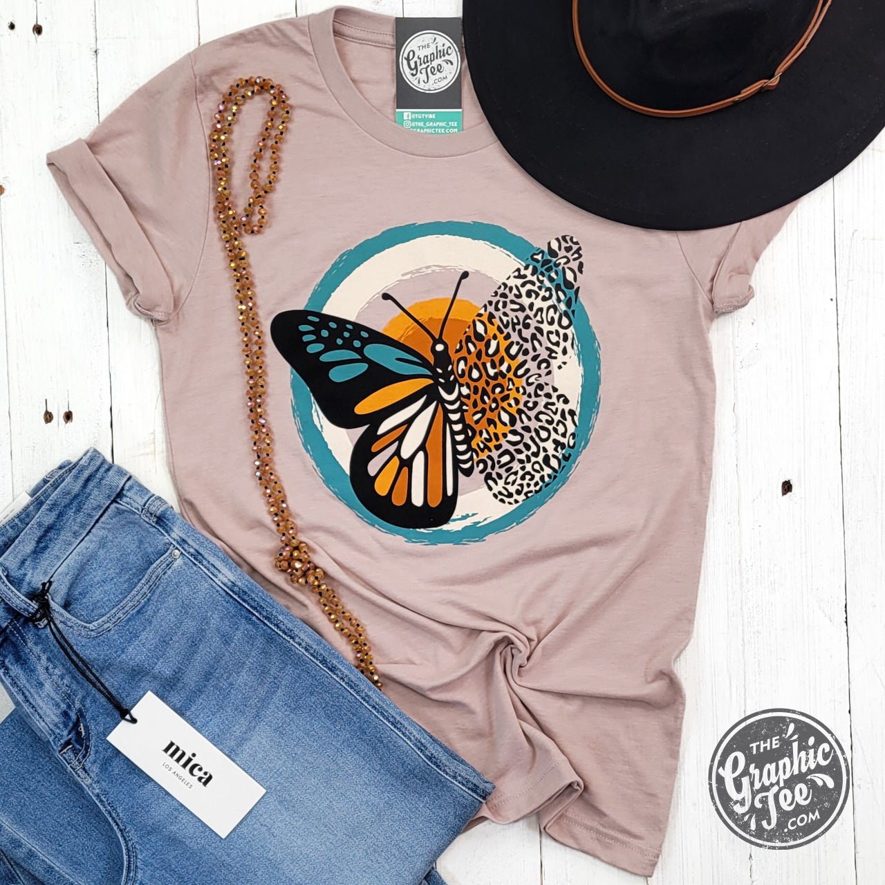 Heather pink short sleeve graphic tee with a fall butterfly design from The Graphic Tee, casual and stylish for everyday wear.