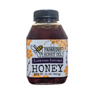 Jar of lavender-infused honey from FARMERS Lavender Co., showing golden honey with lavender flowers.