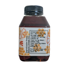 Jar of FARMERS Lavender Co. orange infused honey with a golden-orange hue, showcasing the infused honey in a clear glass jar.