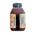 Jar of orange-infused honey from FARMERS Lavender Co., showcasing smooth honey with orange infusion and natural golden color.