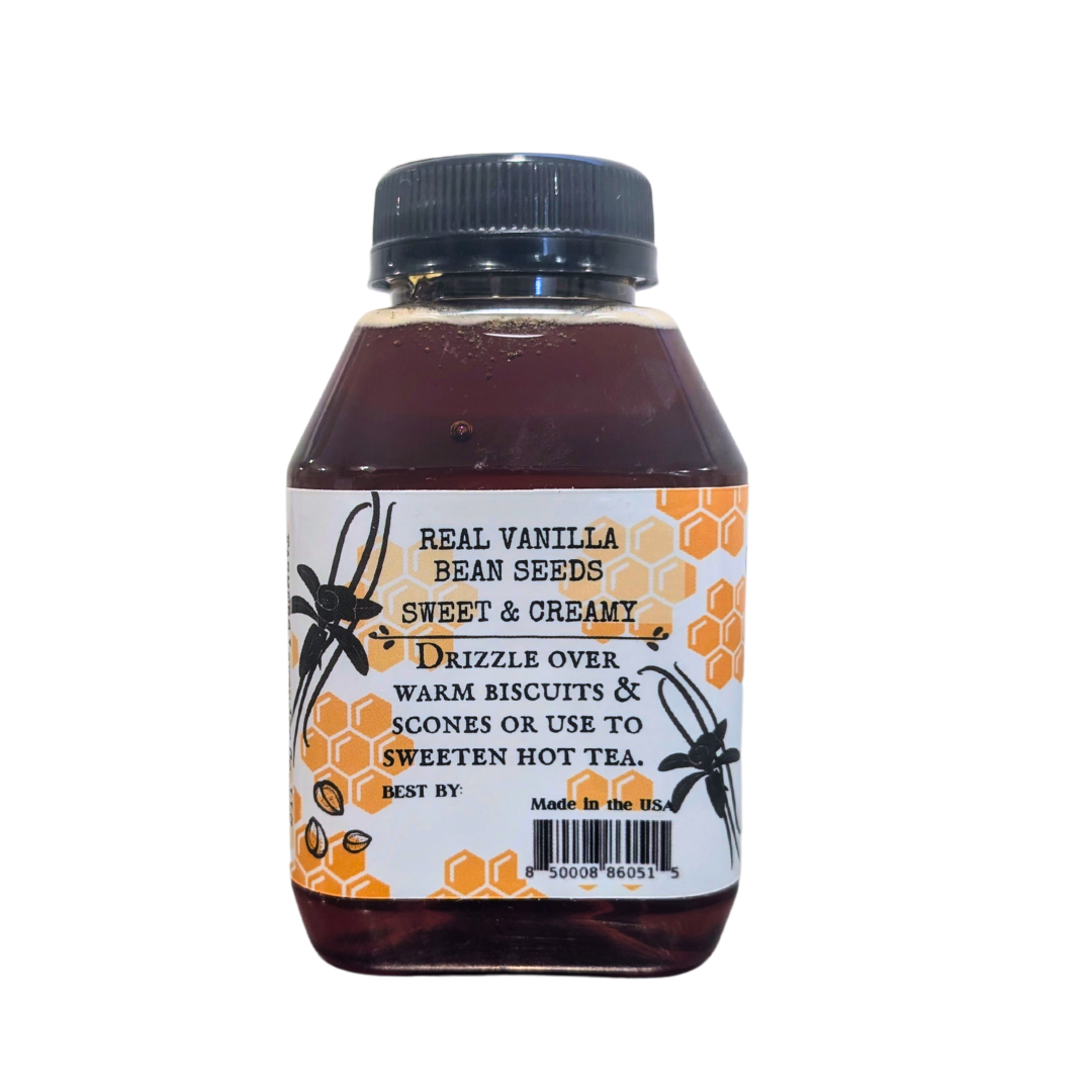 Jar of FARMERS Lavender Co. vanilla bean infused honey with visible vanilla bean pieces, showcasing golden honey and vanilla infusion.