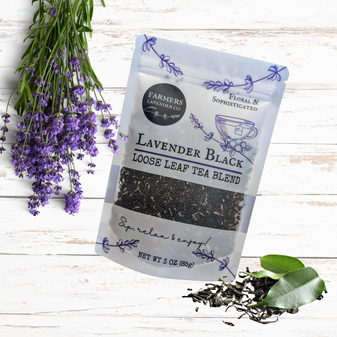Loose leaf lavender black tea blend by FARMERS Lavender Co., showing dried tea leaves with purple and black hues.