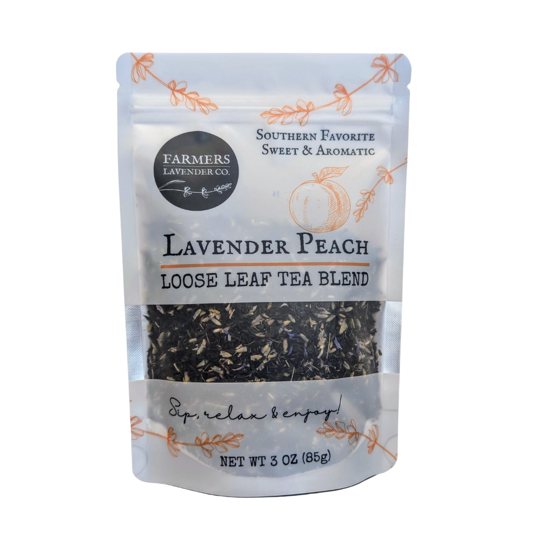 Loose leaf Lavender Peach Tea blend by FARMERS Lavender Co., showing dried lavender and peach pieces in a clear jar.