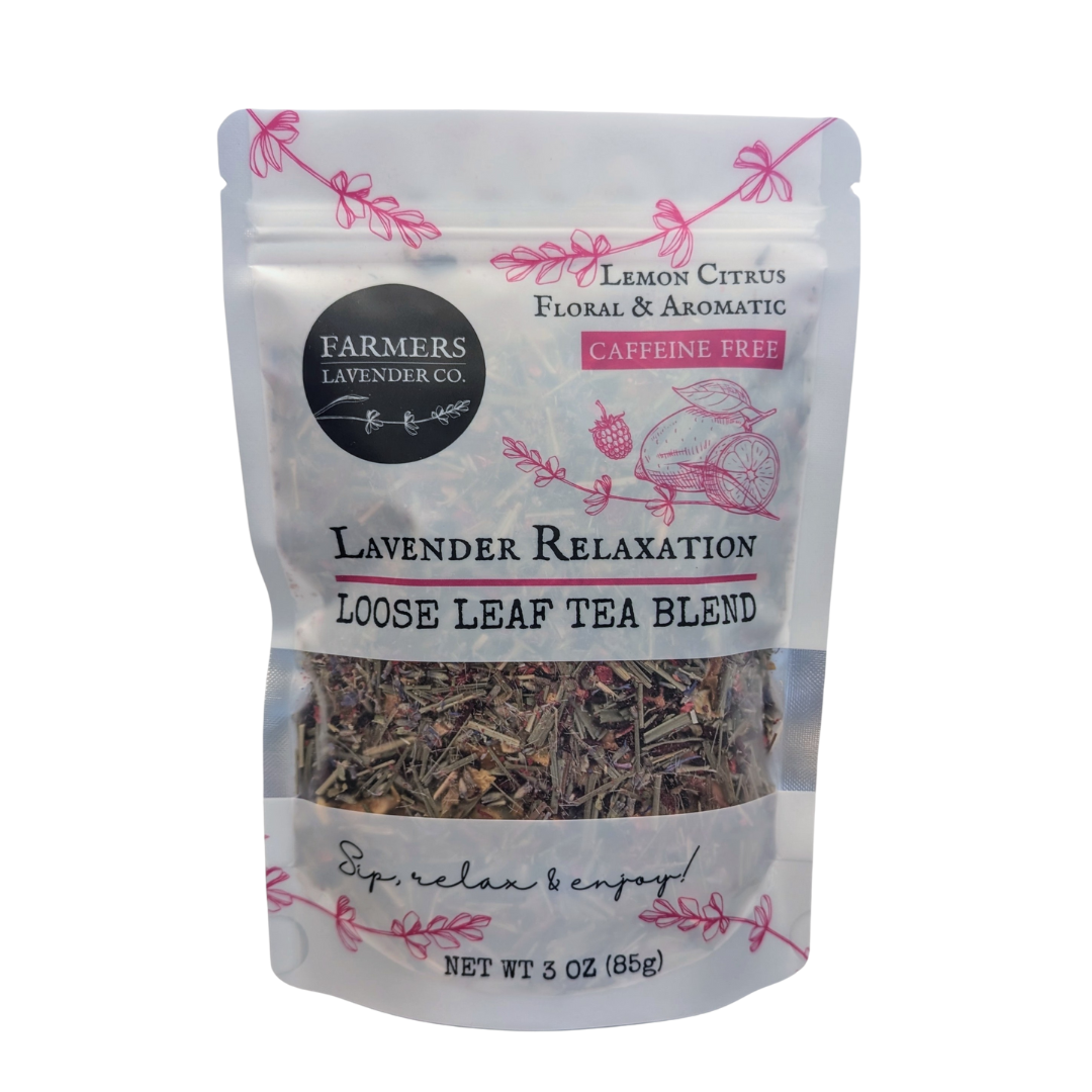 Loose leaf Lavender Relaxation Tea blend by FARMERS Lavender Co. with dried lavender flowers and tea leaves in a clear glass jar.