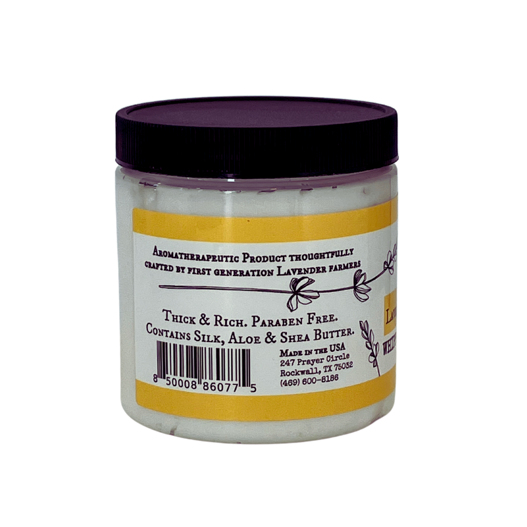 Lavender Chamomile Whipped Body Butter by FARMERS Lavender Co. in a soft, creamy jar with lavender and chamomile herbs visible inside.