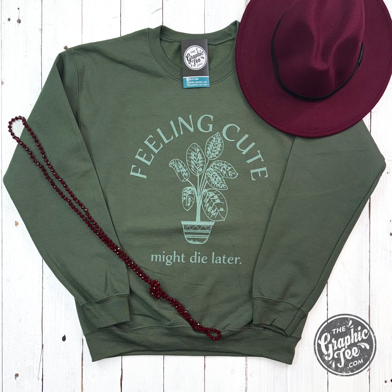 Feeling Cute Might Die Later crewneck sweatshirt from The Graphic Tee, featuring a cozy, casual design with playful text.