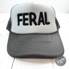 Embroidered Feral design on a casual trucker cap by The Graphic Tee, featuring a structured mesh back and adjustable snap closure.