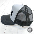 Feral embroidered trucker cap featuring detailed feral animal design on front, adjustable snapback, and mesh back for ventilation.