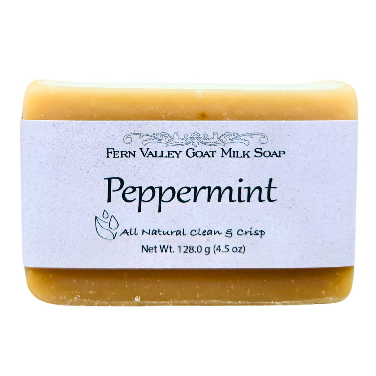 Handmade Fern Valley goat milk soap with natural peppermint scent, showing a bar of soap with peppermint leaves and packaging.