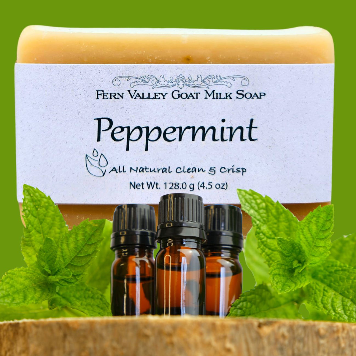 Handmade Fern Valley Goat Milk Soap with natural peppermint scent, showcasing a bar of soap with peppermint leaves on a rustic surface.