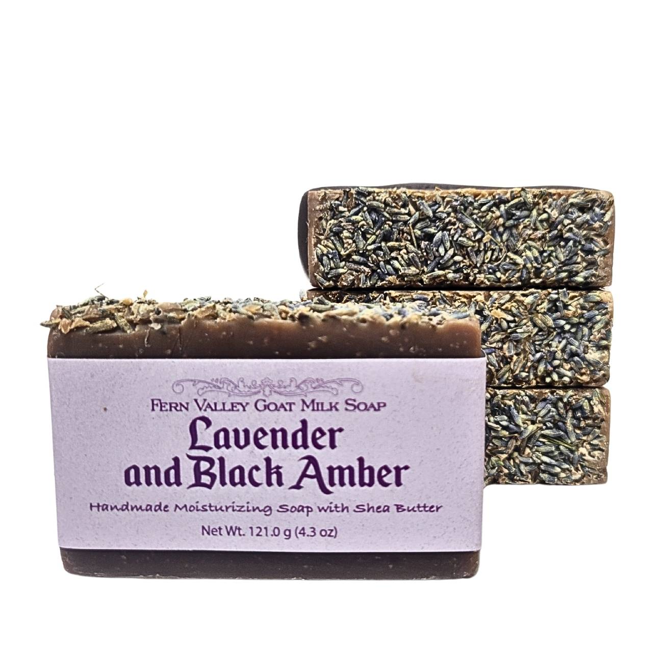 Handmade Fern Valley Goat Milk Soap with lavender and black amber, showcasing a bar with lavender flowers and black amber accents.