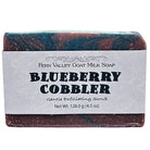 Fern Valley Goat Milk Soap with Blueberry Cobbler exfoliating scrub, showcasing a creamy soap bar with blueberry and cobbler scent.