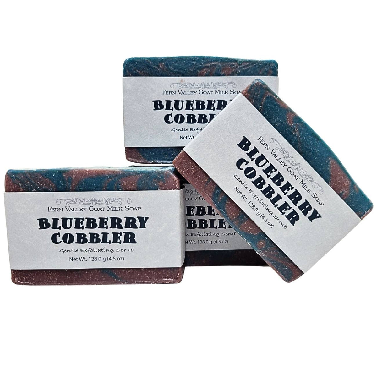 Fern Valley Goat Milk Soap with blueberry cobbler scent, featuring exfoliating scrub texture and vibrant blue and purple hues.