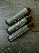 Unlabeled beeswax lip balm from Five Oaks Farm with natural, unscented formula in a small container.