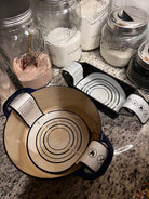 Five Oaks Farm Dough Sling used for baking, featuring a durable fabric strap and wooden handles for easy dough handling.