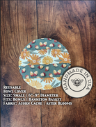 Small bowl and banneton covers from Five Oaks Farm, decorated with acorn, cache, and aster blooms, for bread proofing.