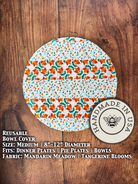 Manadrin Meadow Tangerine blooms on a Medium Bowl and Banneton Covers from Five Oaks Farm, featuring floral embroidery and natural textures.