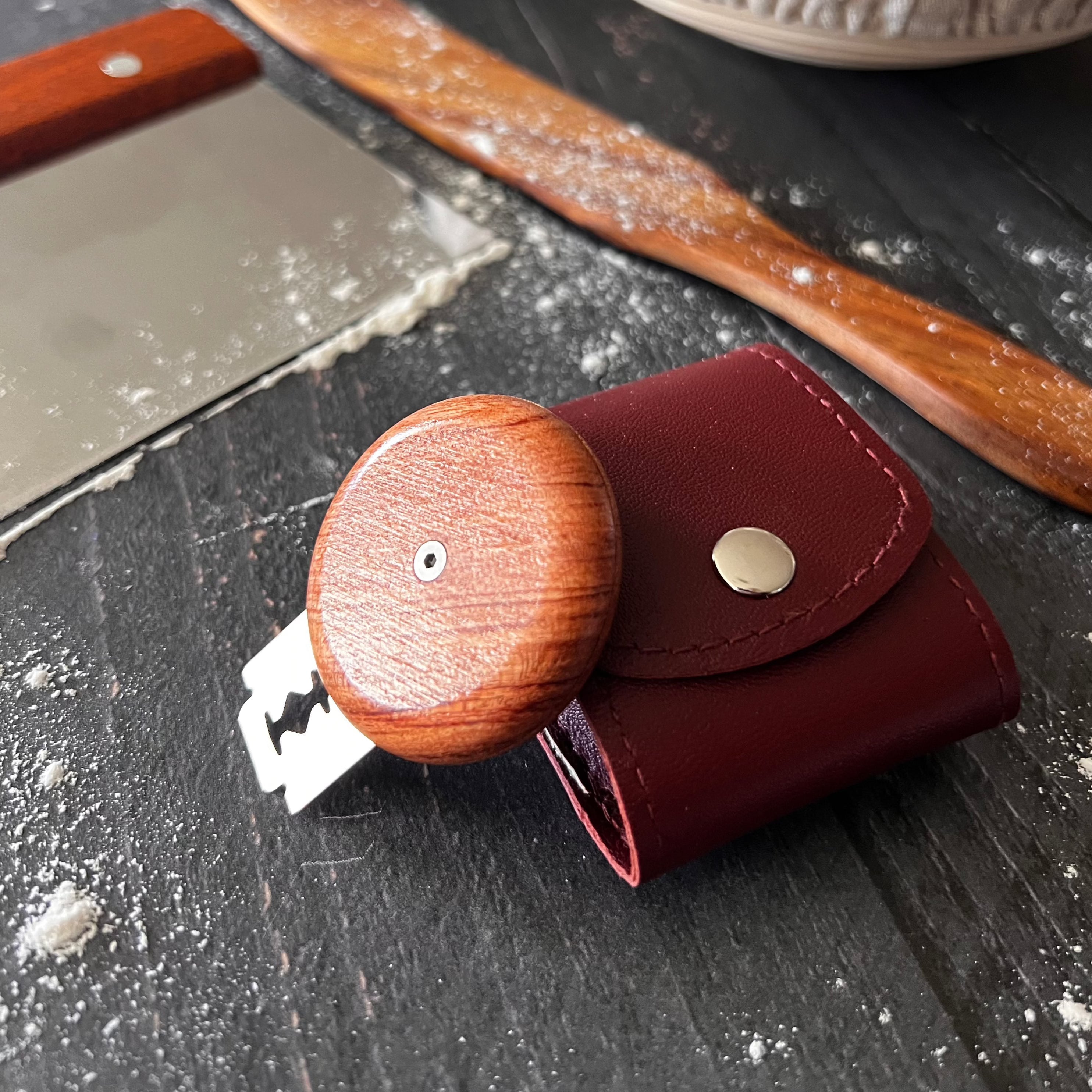 Five Oaks Farm bread lame scoring tool, handmade from wood and metal, with a sharp blade for scoring artisan bread dough.