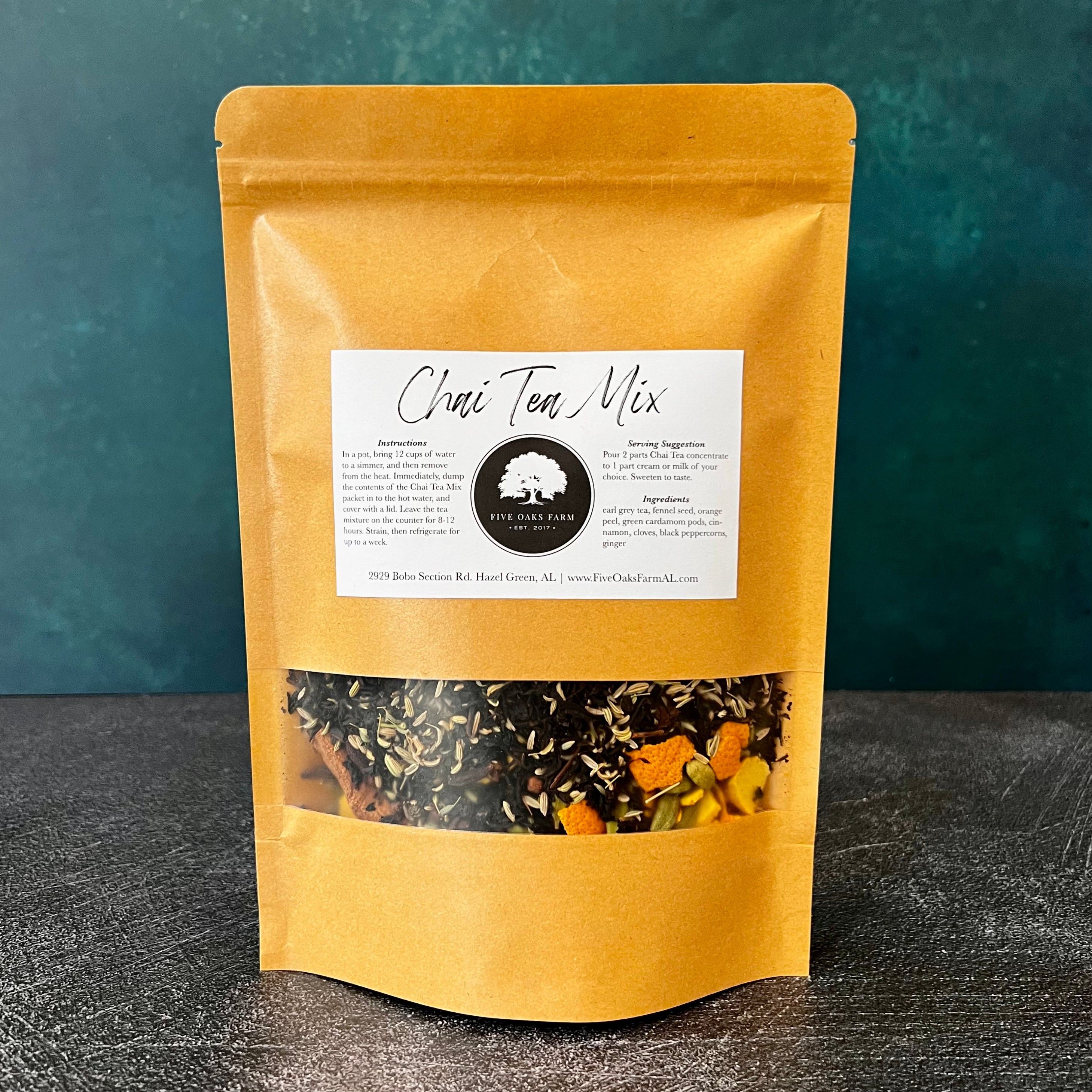 A bowl of Five Oaks Farm from-the-farm Chai Tea Mix with spices and tea leaves on a rustic wooden surface.