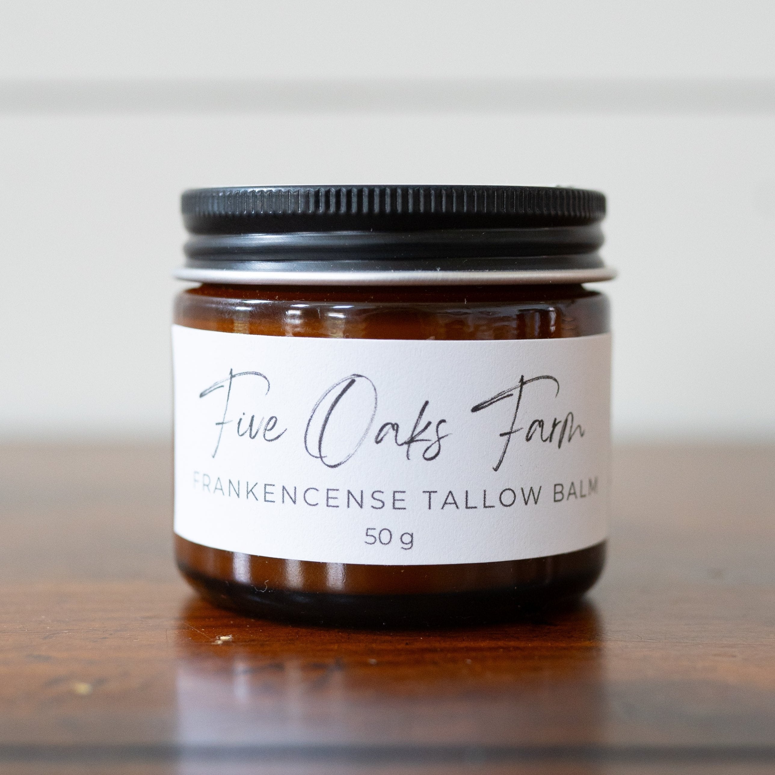 Frankencense Tallow Balm from Five Oaks Farm, natural skincare product in a jar with a creamy texture and herbal scent.