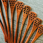 Honey spoon from Five Oaks Farm, natural wooden utensil with a rounded tip, used for serving honey from the farm.