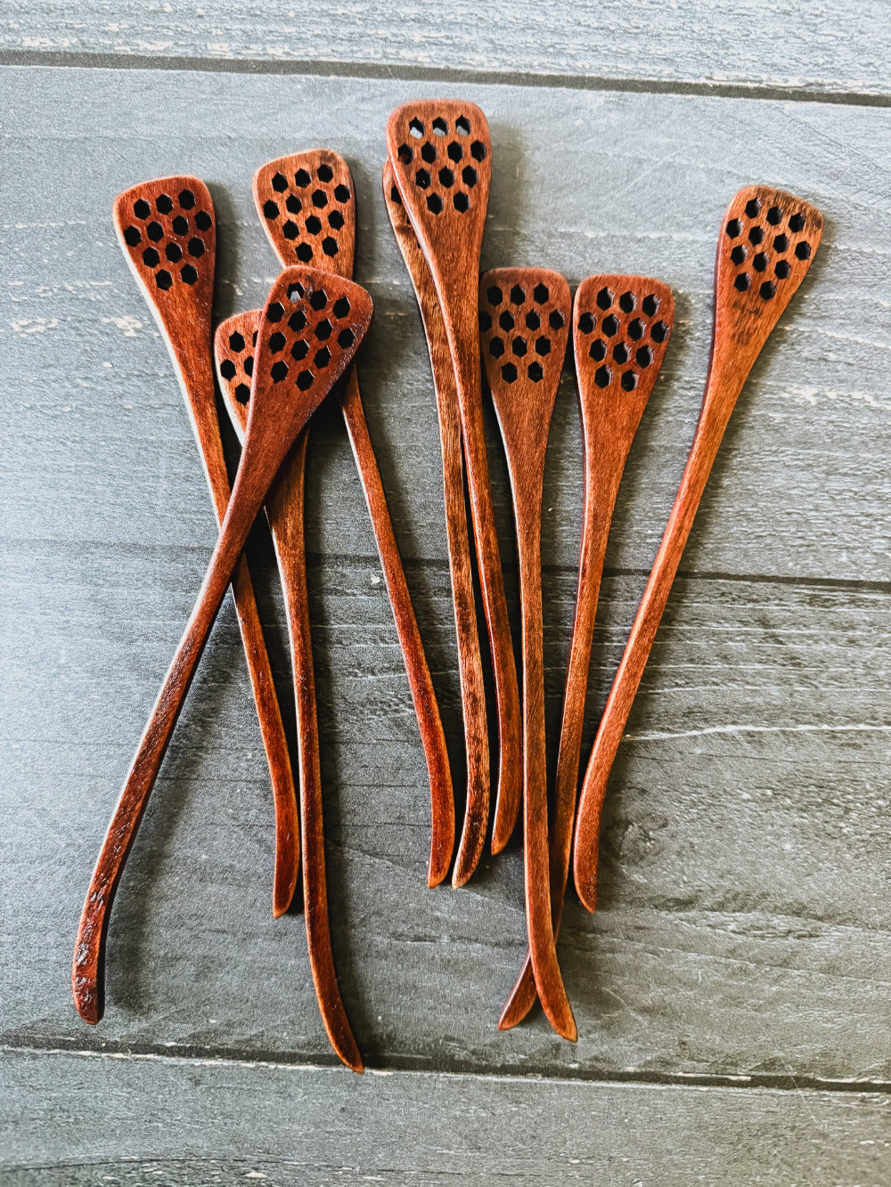 Honey spoon from Five Oaks Farm, natural wooden utensil for serving honey, shown on a rustic farm setting.