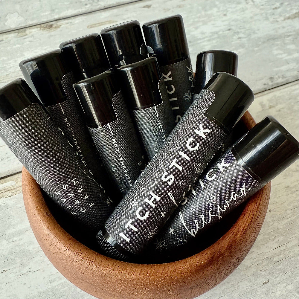 Natural remedy Itch Stick from Five Oaks Farm, featuring a wooden applicator and herbal ingredients for soothing skin relief.