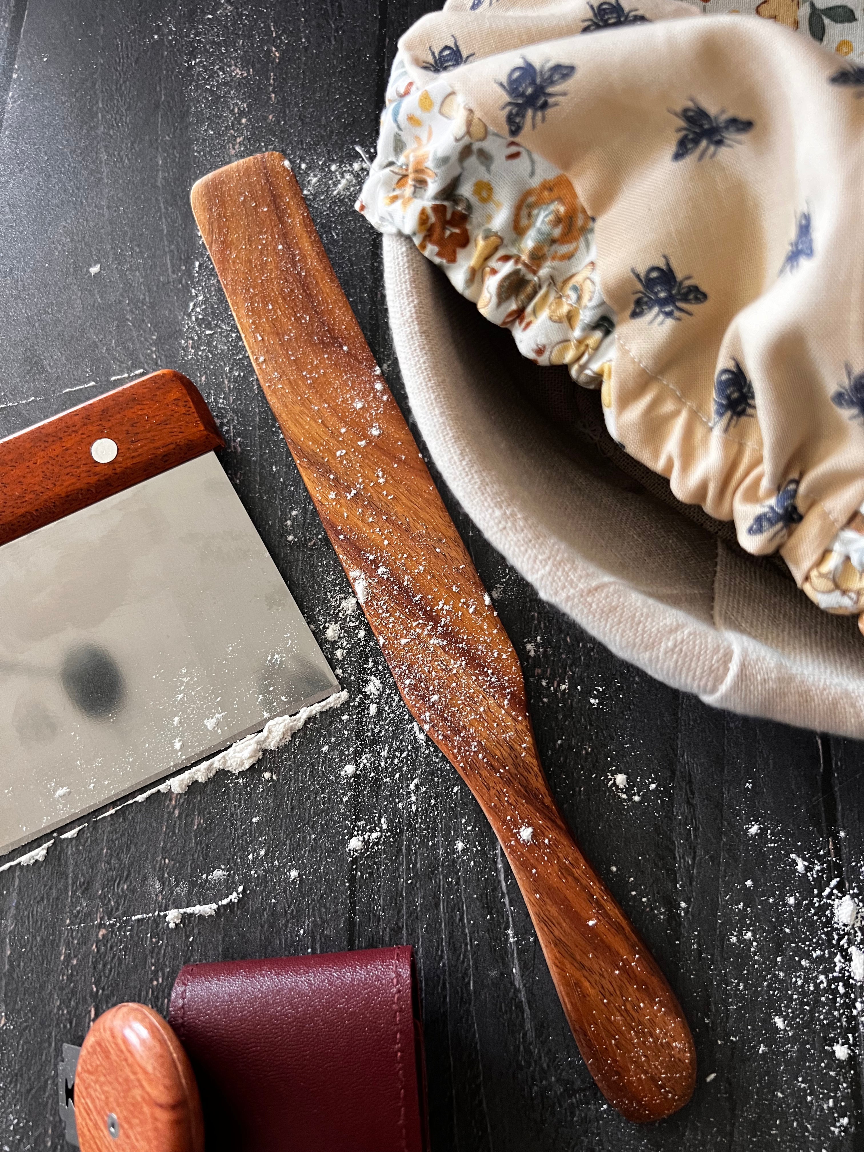 Handcrafted wooden Spurtle from Five Oaks Farm, showcasing its smooth finish and traditional design for cooking and stirring.