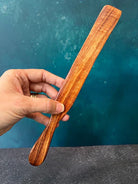 Handcrafted wooden spurtle from Five Oaks Farm, showcasing its smooth finish and traditional design for cooking and stirring.
