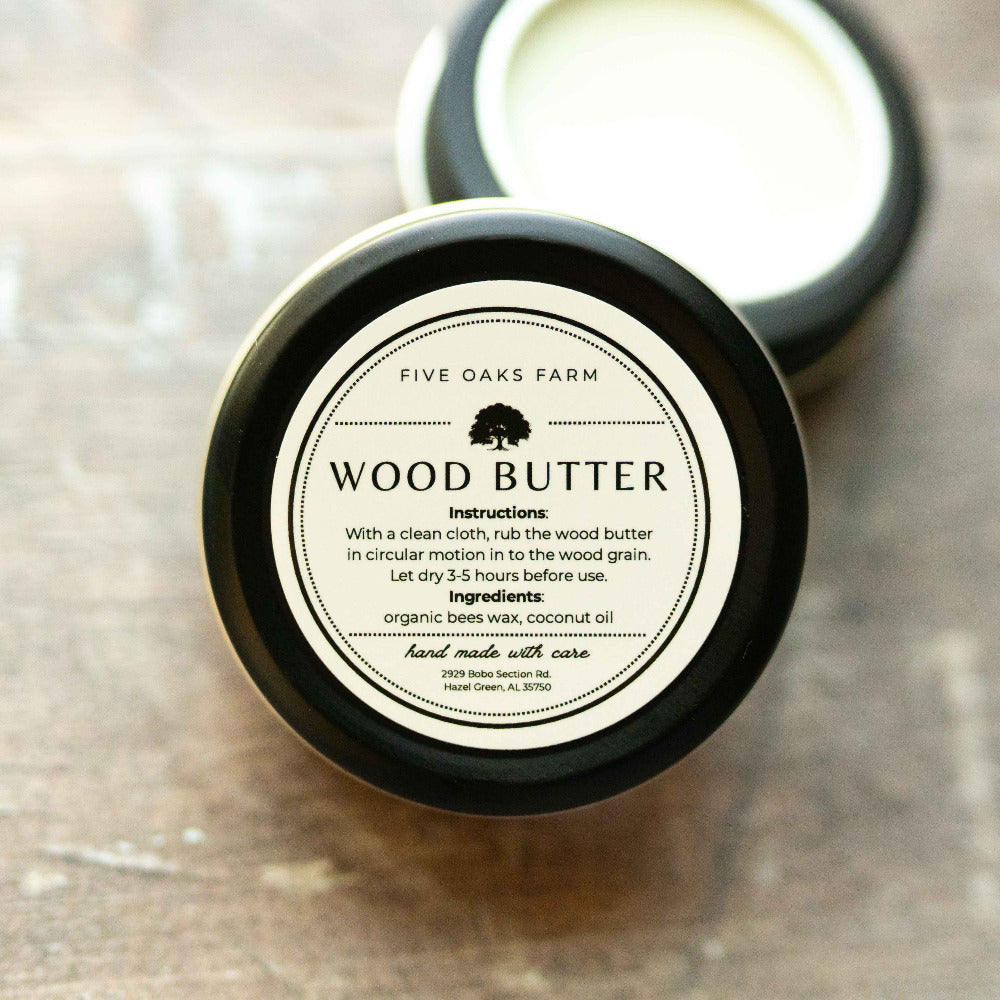 Creamy wood butter from Five Oaks Farm, made from natural ingredients, shown in a rustic container with a wooden background.