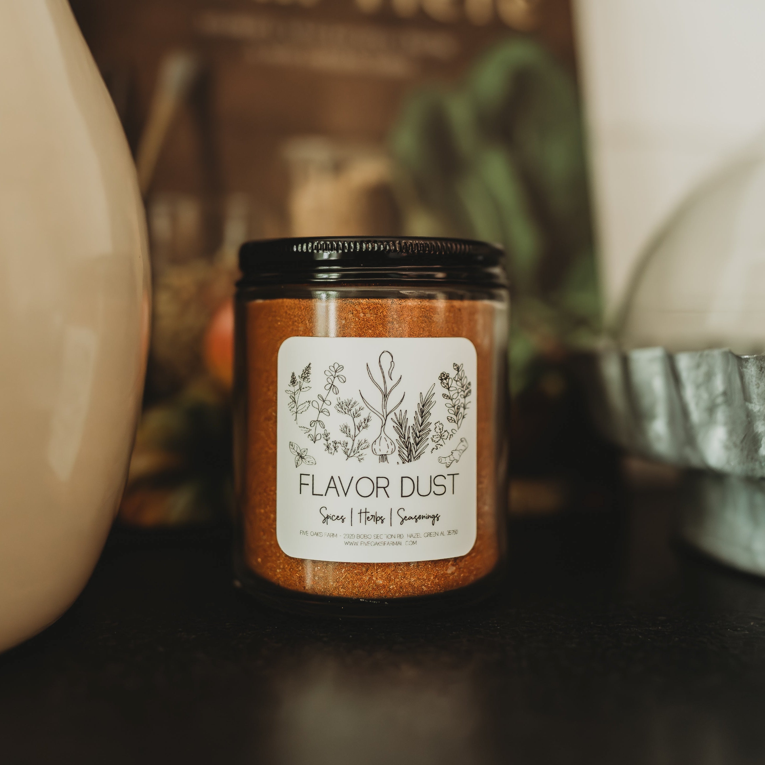 Five Oaks Farm Flavor Dust shaker with farm-fresh spice blend in a clear jar, close-up view of the seasoning powder.