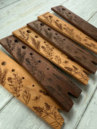 Five Oaks Farm walnut herb stripper showing a hand holding the tool with herbs ready to be stripped.