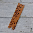 Five Oaks Farm walnut herb stripper showing a hand holding the tool with herbs ready to be stripped.