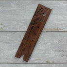 Five Oaks Farm walnut herb stripper with multiple holes for quickly stripping herbs from stems.