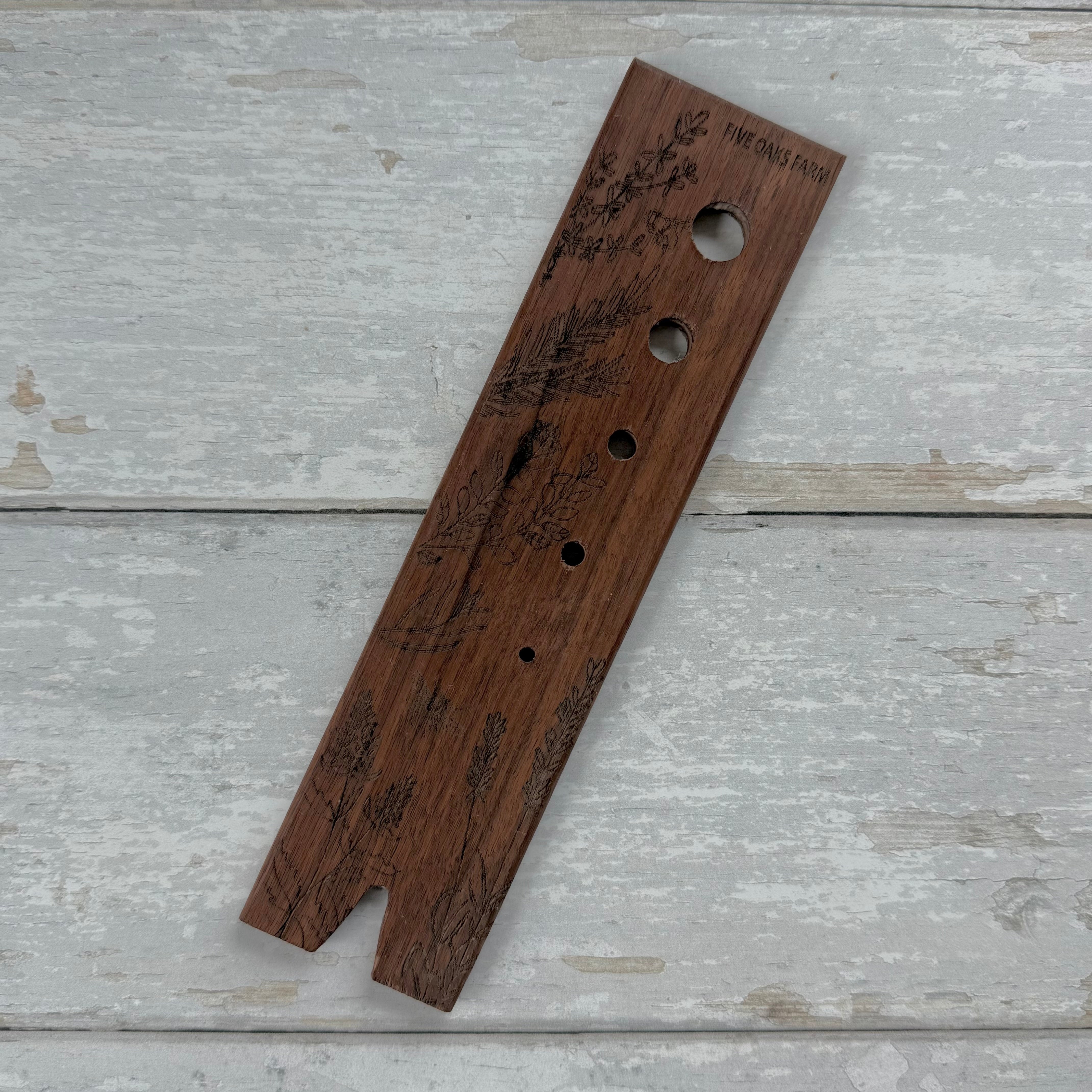 Five Oaks Farm walnut herb stripper with multiple holes for quickly stripping herbs from stems.