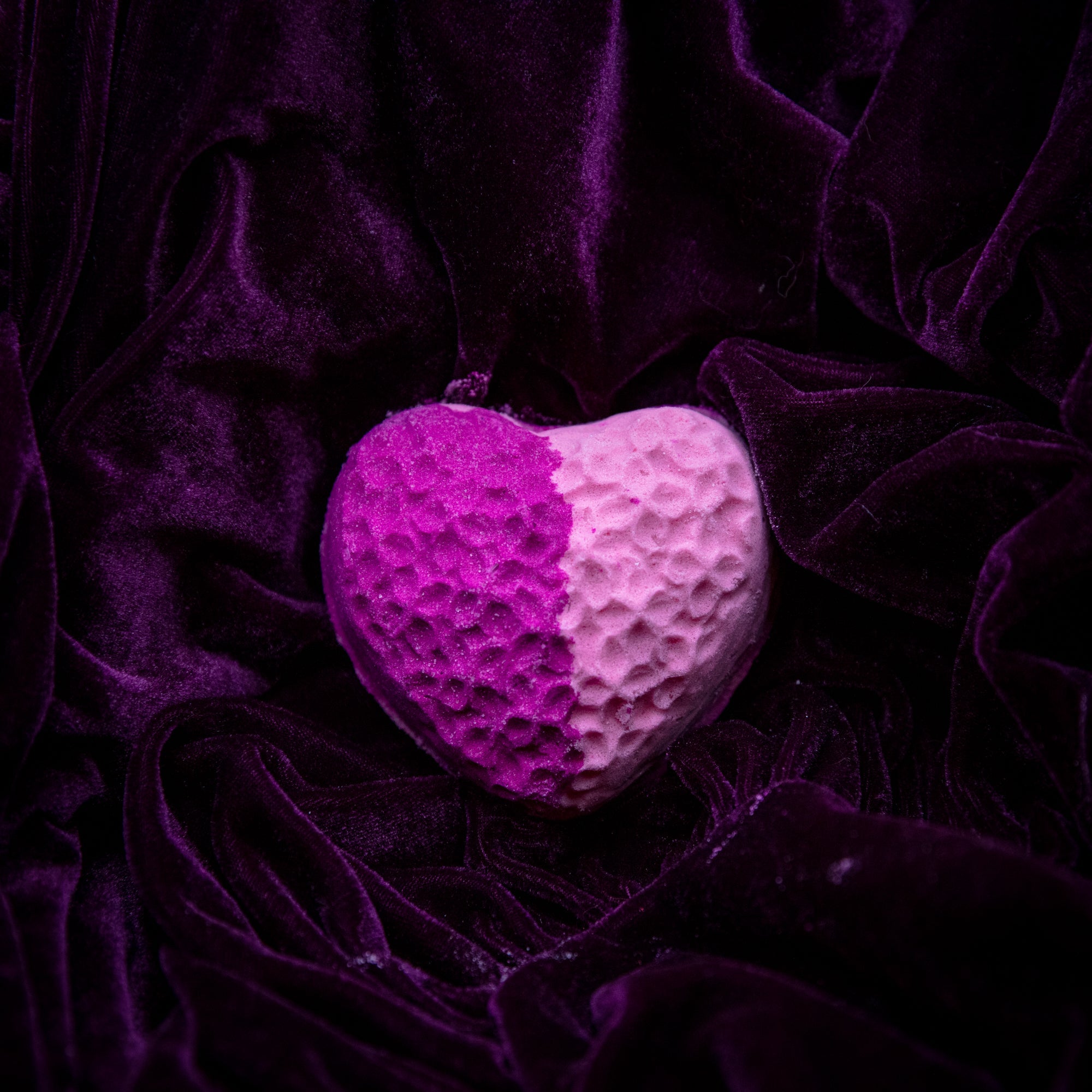 Fragrant Jewels Wicked Love bath bomb with a ring inside, showcasing a colorful, round bath bomb in a relaxing setting.