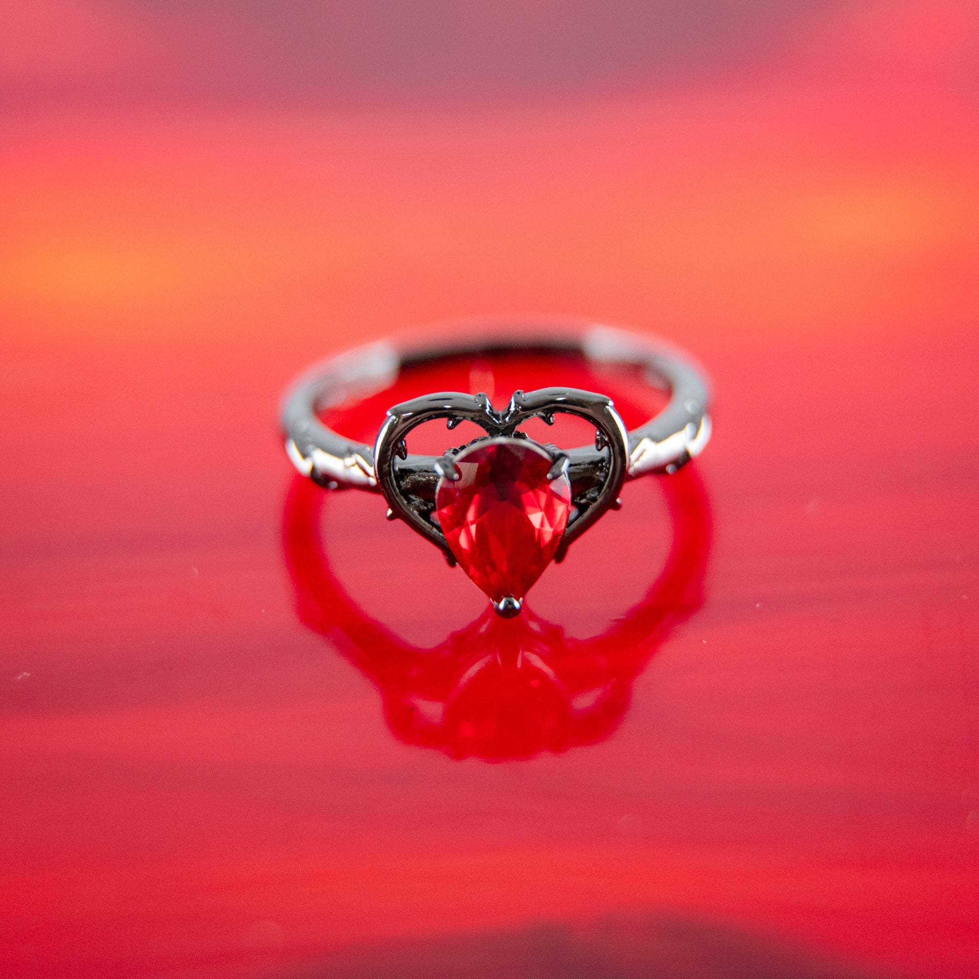 Fragrant Jewels Wicked Love bath bomb with a ring inside, showcasing vibrant colors and a luxurious bath bomb design.