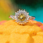 Fragrant Jewels Jewel Candle with sunflower design and embedded ring, featuring a decorative sunflower pattern and luxurious candle wax.