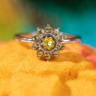 Fragrant Jewels Jewel Candle with sunflower design and embedded ring, featuring a warm, floral scent and decorative yellow sunflower motif.