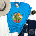 The Graphic Tee Free Hugs Cactus short sleeve crewneck graphic T-shirt featuring a playful cactus design on a white background.