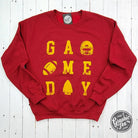 Red and gold crewneck sweatshirt featuring Kansas City graphics, made by The Graphic Tee, casual apparel for game day.