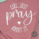 Girl wearing Heather Mauve unisex V-neck T-shirt with "Just Pray About It" graphic, from The Graphic Tee collection.