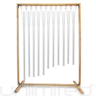 Set of 11 Gongs Unlimited planetary tuned healing chimes with wooden stand, showcasing colorful, metal chimes hanging from a wooden frame.