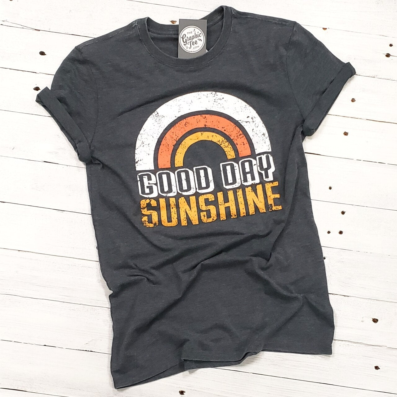 Vintage Good Day Sunshine SS Graphic Tee by The Graphic Tee, featuring a retro sun and vibrant design on soft cotton fabric.